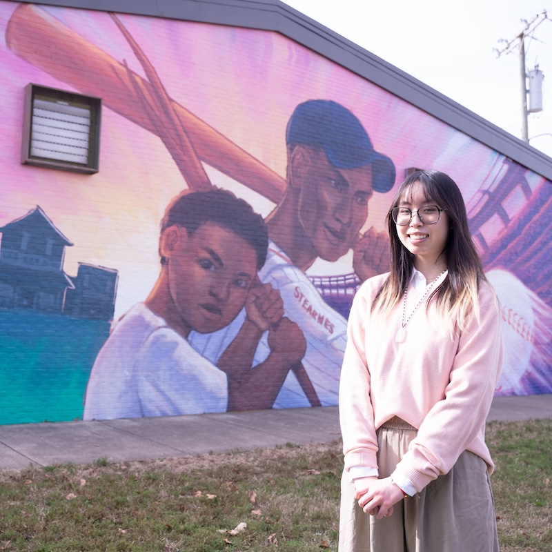 Joanna Wu with original community mural