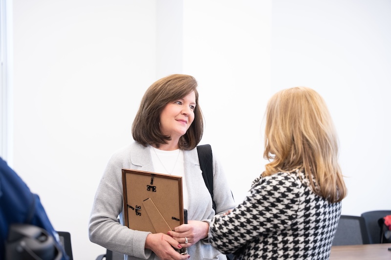 Kim Powell talking with her supervisor at the ELDP graduation ceremony.