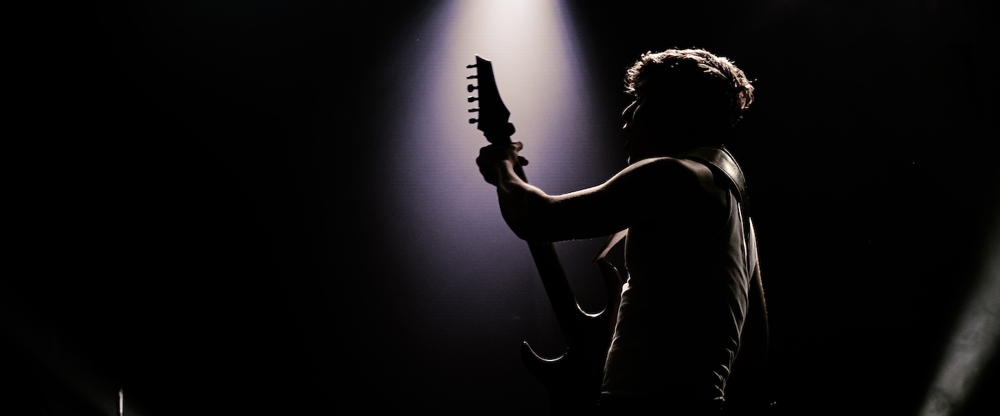 silhouette of musician playing guitar 
