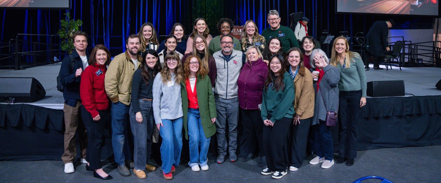 Sam Simpkins poses with University Marketing and Communications team