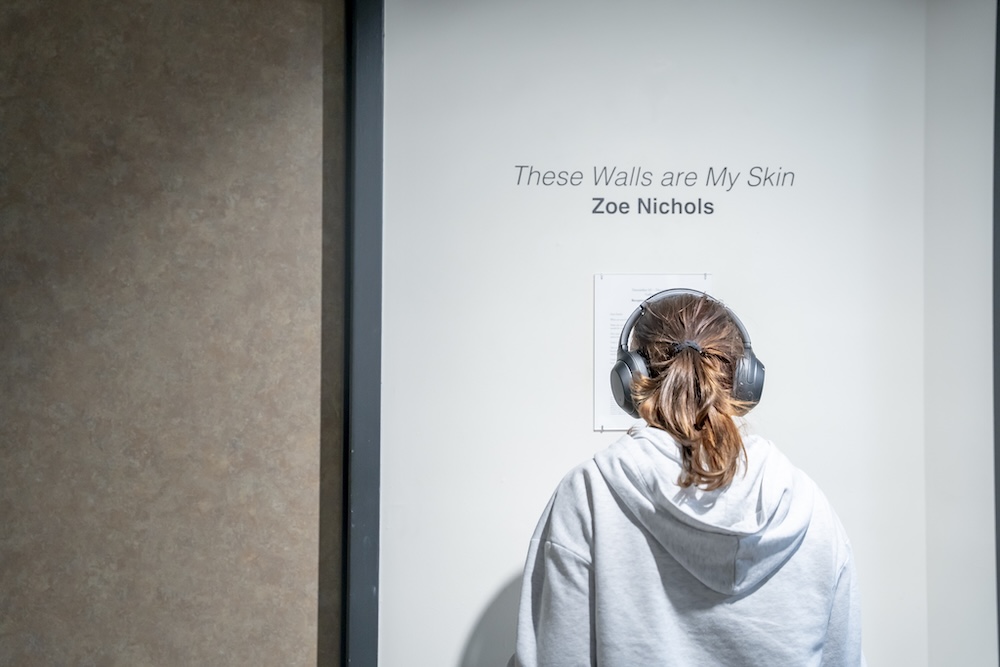 someone looking at title of the show on a wall