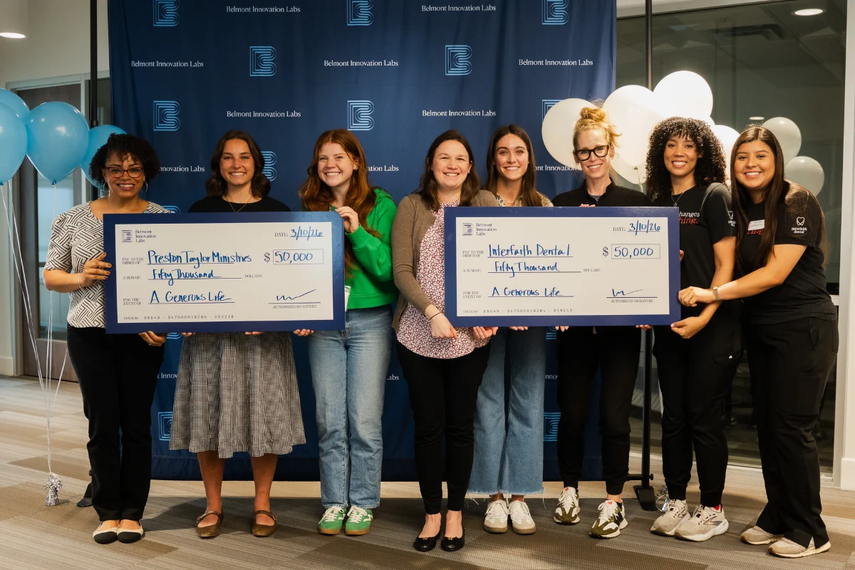 Nonprofit teams hold giant checks