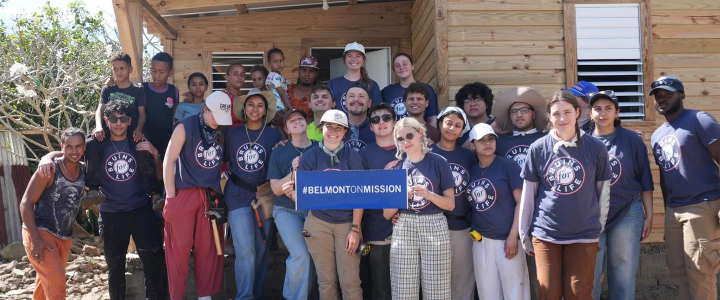 Students on a mission trip, smiling at camera
