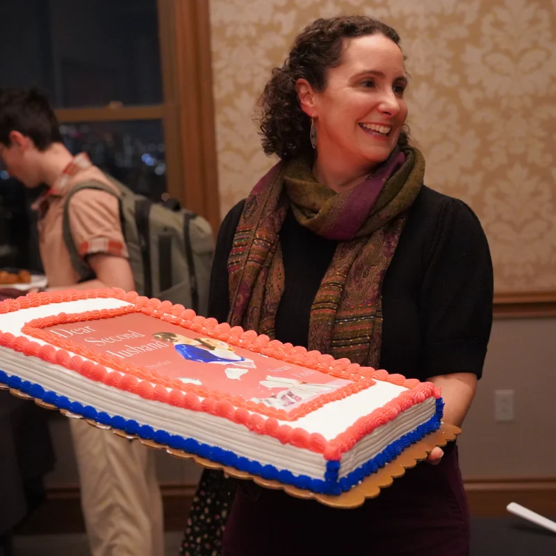 Susan Finch with a cake decorated like the cover of her book