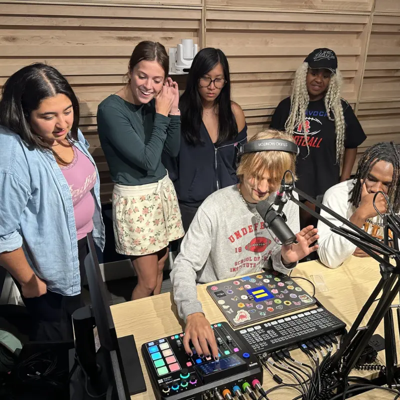 noah Kammer and students gathered in podcast studio 