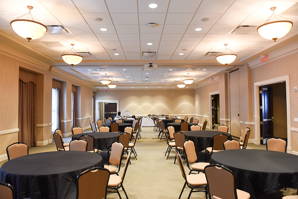 Frist Lecture Hall set up with round tables and chairs.
