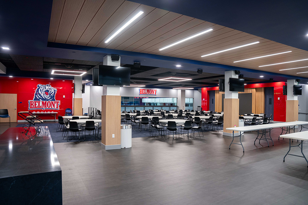 Vince Gill Room empty, but showing screens, tables, and other features that are apart of the room.