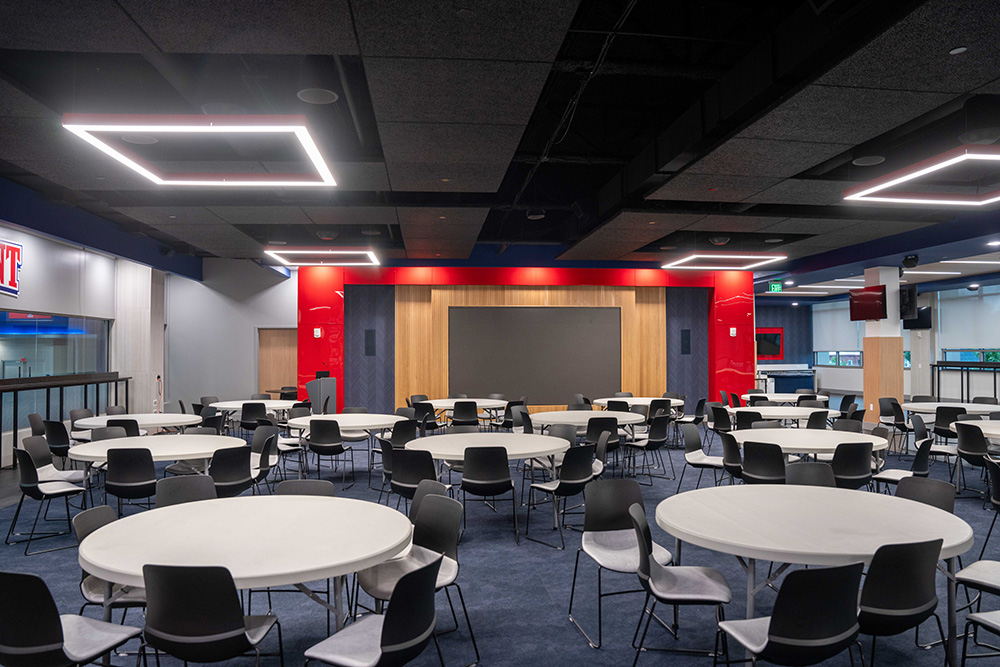 Vince Gill Room empty, but showing screens and table and chairs that are apart of the room.