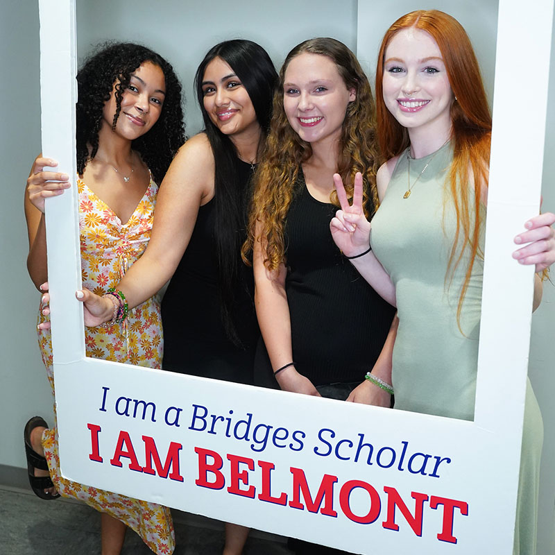 Four bridges students posing in a photo frame that says I AM BELMONT