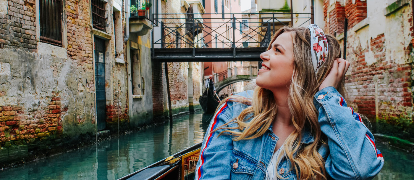 woman smiling and looking at view of buildings