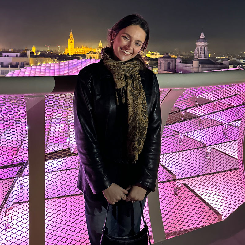 Female student standing in front of scenery in Spain
