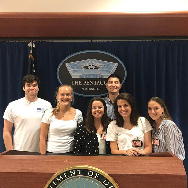 Belmont USA students pose in front of the podium at the Pentagon in Washington