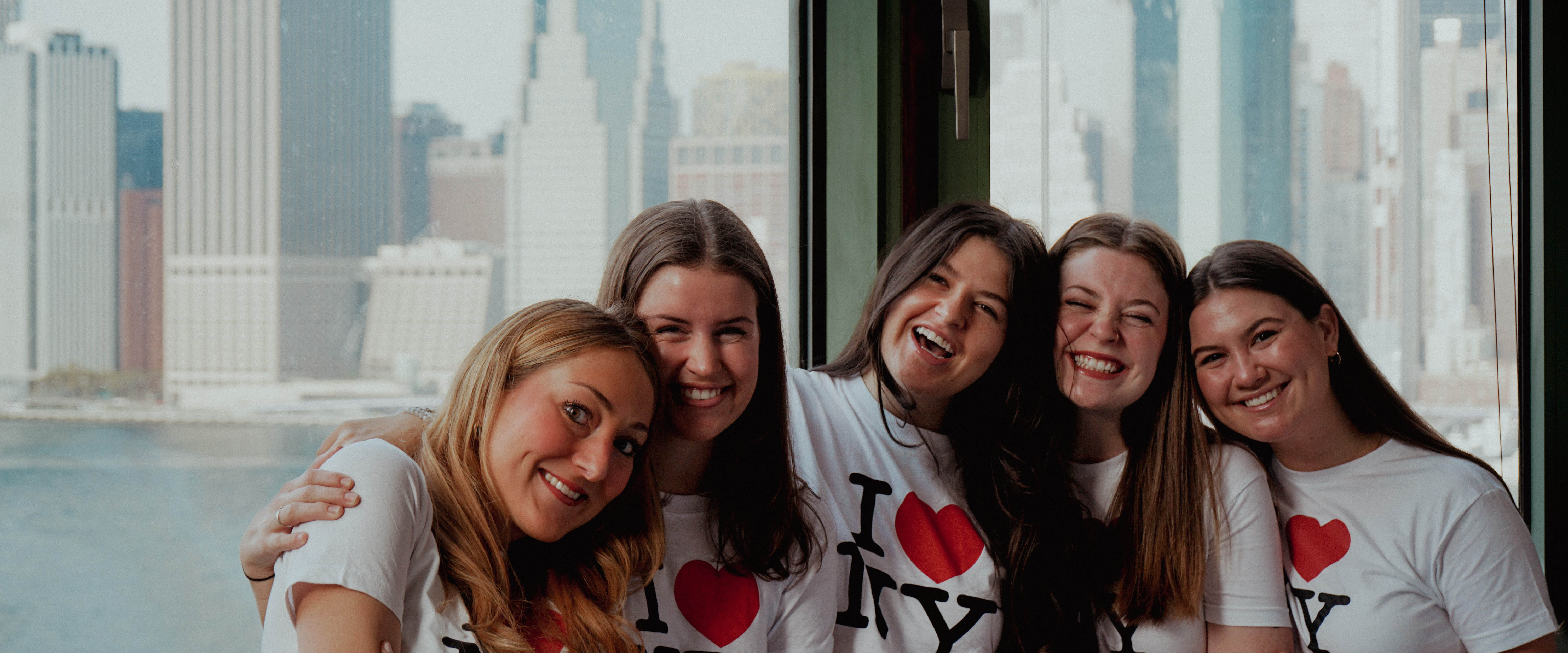 Students from Belmont East pose for picture in front of NYC skyline if I Heart NYC shirts