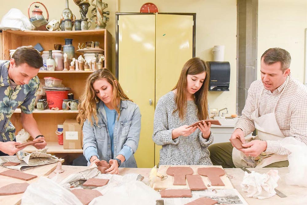 students and faculty in ceramics